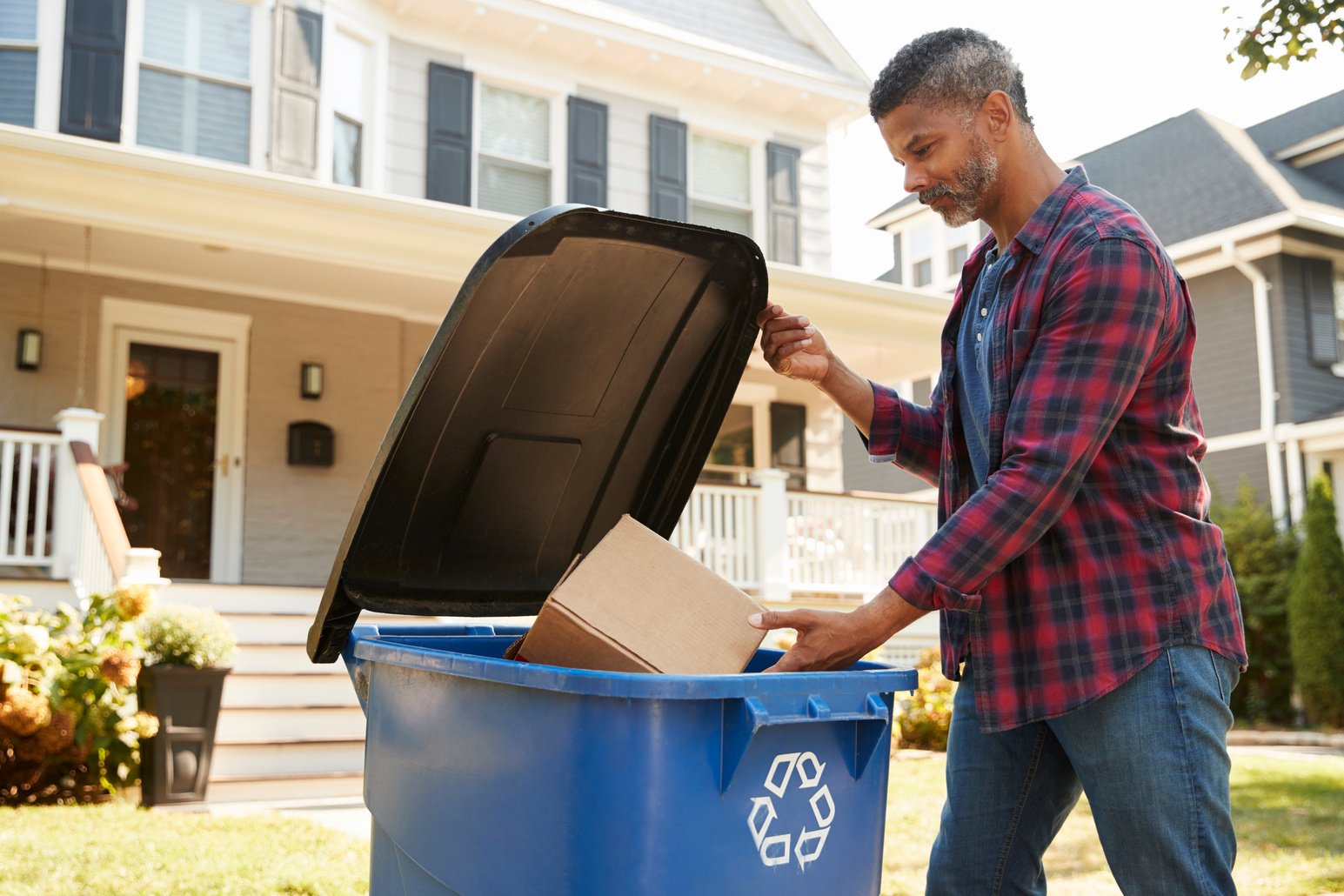 Man Filling Recycling Bin 