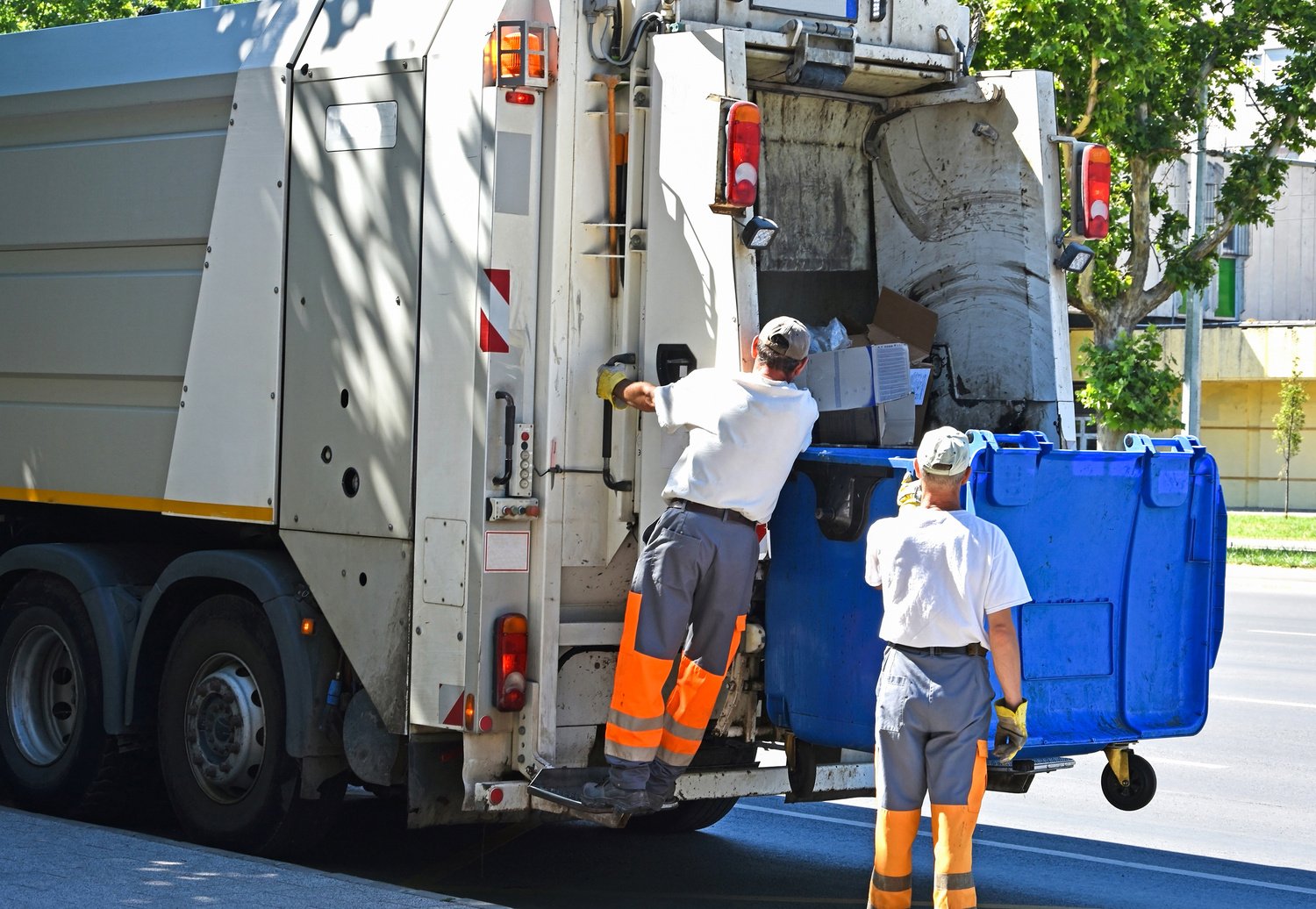 Garbage truck works in the city street